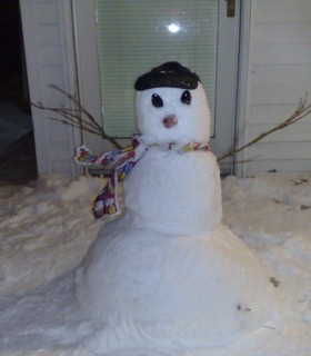 Snow man with his cap on